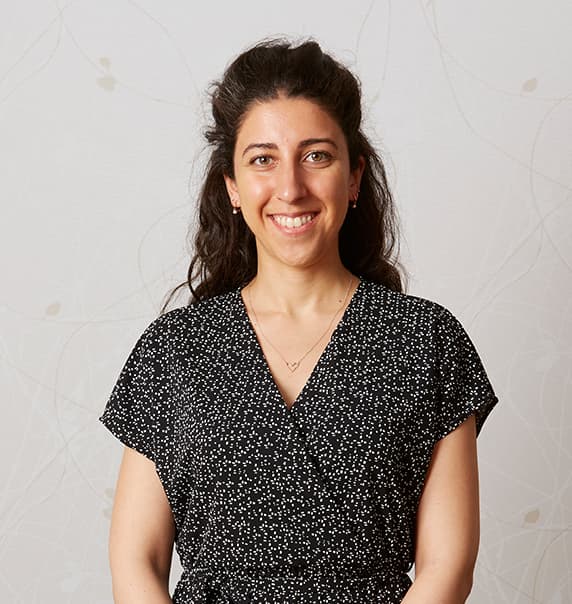 Partner Antonia Frangakis stood in front of a white wall.