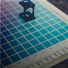 Color palette book with magnifying glass.