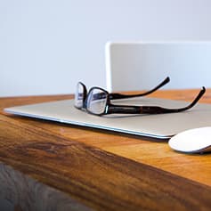 Glasses sitting on laptop.