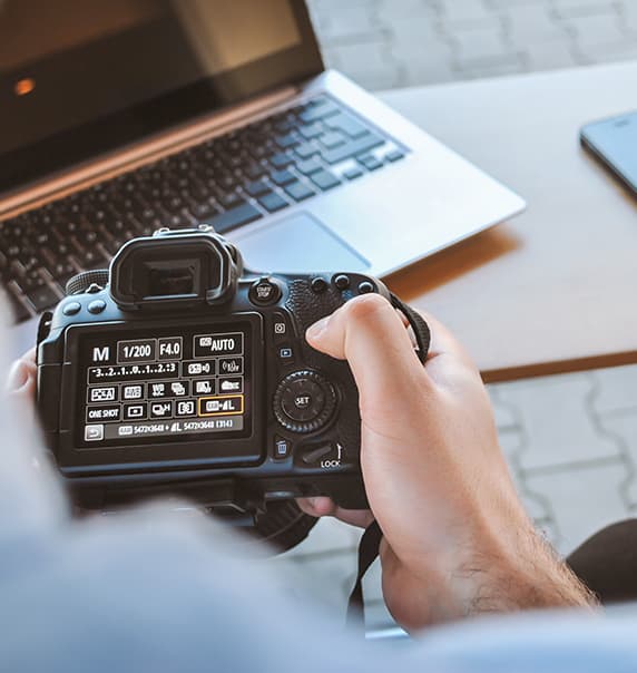 Man changing settings on camera.