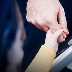Child holding an elderly hand.