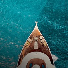 front of a yacht on blue waters.