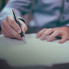 Person making notes on document.