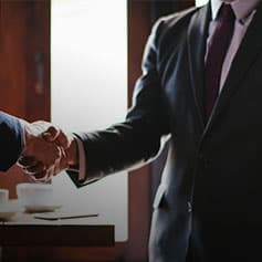 Two business men shaking hands.