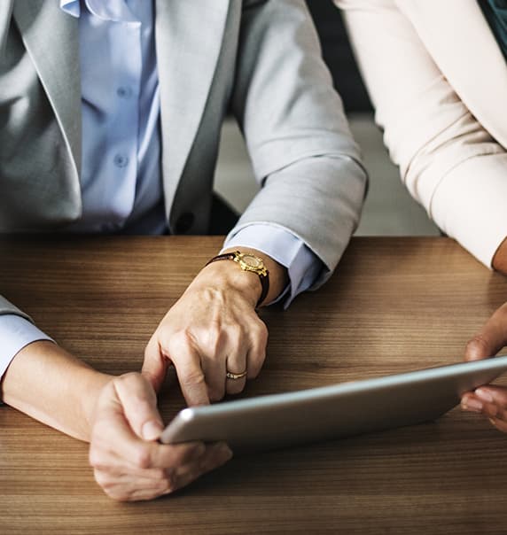 Two people looking at document on tablet