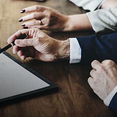 Three people discussing a document.