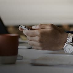 Person on phone at table.