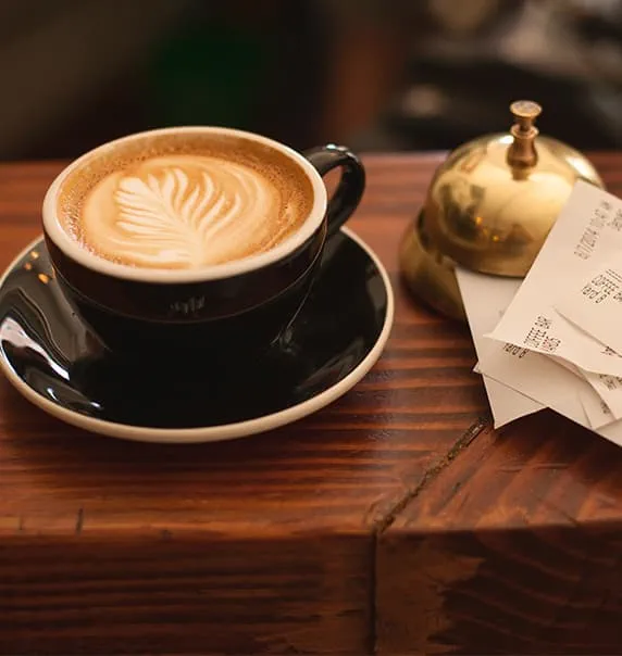 Coffee sitting next to reception bell