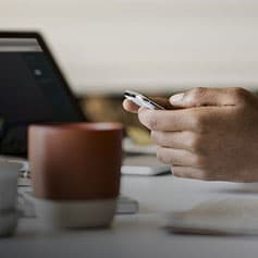 Person on phone at table.