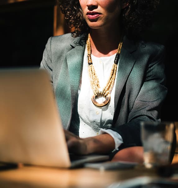 Woman sitting using laptop.