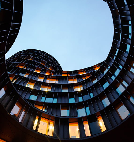 looking up at a curved building.