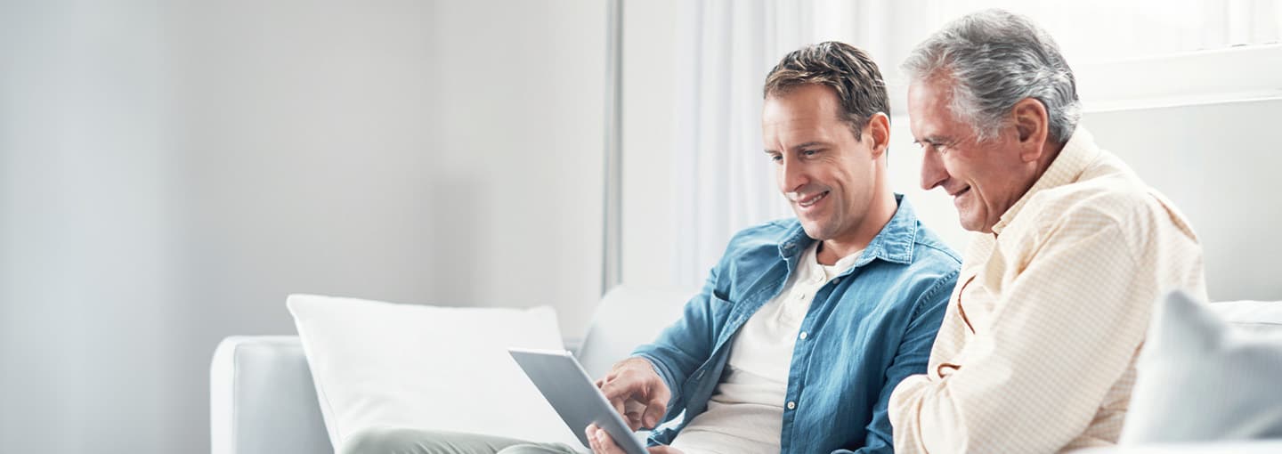 Father and son using a laptop.