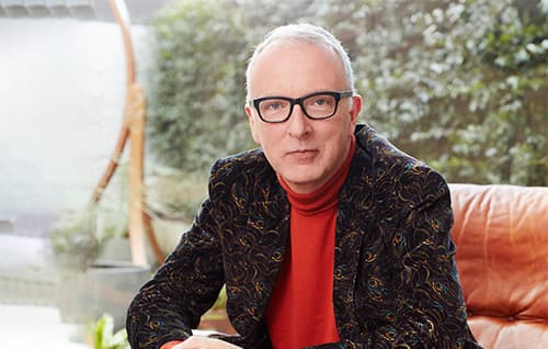 Picture of Simon Carter sitting relaxed in an armchair. 