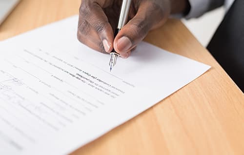 Man signing papers with fountain pen