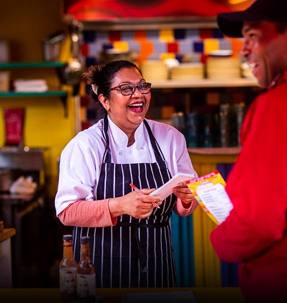 Woman taking order at restaurant.